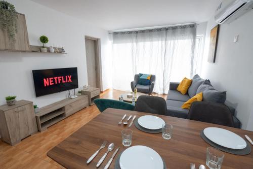 a living room with a couch and a table at Napa Centrale Suites in Ayia Napa