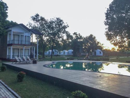 a house with a swimming pool in front of a house at The Lion Kingdom Sigiriya in Sigiriya