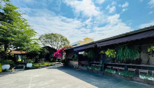 a building with benches and flowers on the side of it at Follow Me designed B&B in Dongshan