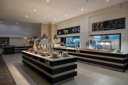 a restaurant with a counter with drinks on it at Monte Baia Uludağ - Full Board Plus in Uludag