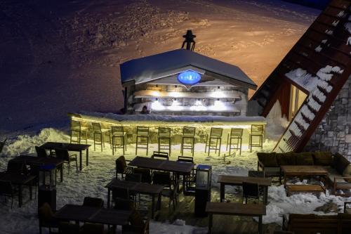 a restaurant in the snow at night with lights at Monte Baia Uludağ - Full Board Plus in Uludag