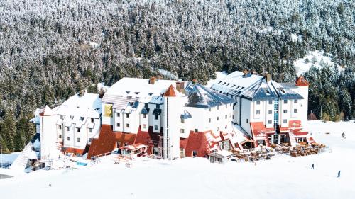 a large building in the snow with snow covered trees at Monte Baia Uludağ - Full Board Plus in Uludag