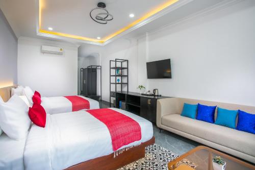 a hotel room with a bed and a couch at Cambana Poipet Hotel in Krong Poi Pet