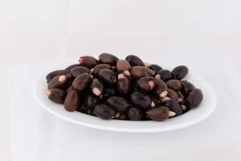 a pile of beans on a white plate at HELLAS PALACE ROOMS balcony in Sparti