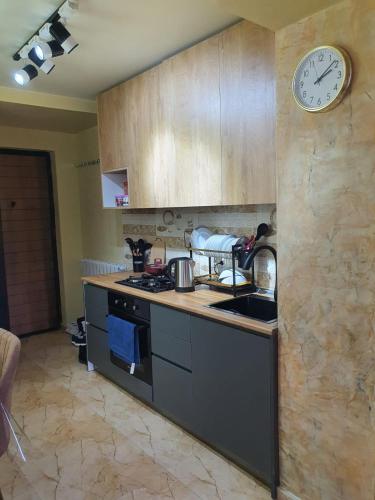 a kitchen with a sink and a clock on the wall at Prima home 