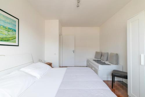 a white bedroom with a bed and a desk at LA MAR Apartment Spinea in Spinea