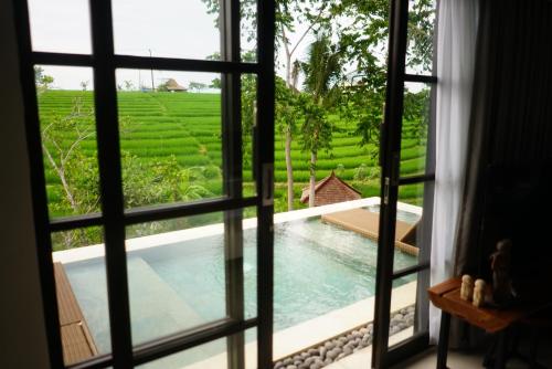 a view from the window of a villa with a swimming pool at Paripadi Private Villa and Sanctuary in Canggu