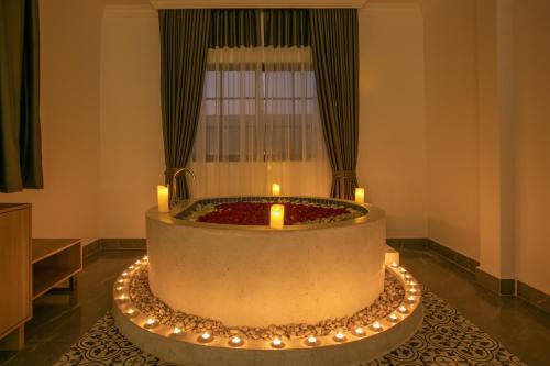 a room with a large tub with candles in it at Cambana Poipet Hotel in Krong Poi Pet