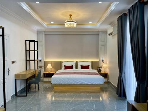 a hotel room with a bed and a desk and a desk at Cambana Poipet Hotel in Krong Poi Pet