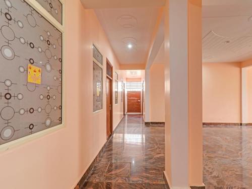 a hallway in a building with a tile floor at Srv Inn in Nilmatha