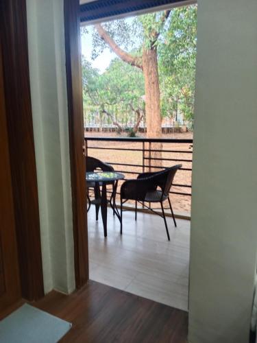 a room with a balcony with a table and chairs at Villa Marilyn Resort and Hotel in Coron