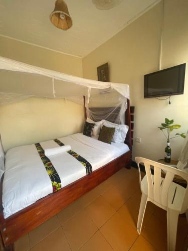 a bedroom with a bed with a canopy at Suba Motel in Kihihi