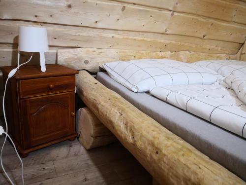 a bedroom with two beds in a log cabin at Chata Zuzka pod Babou horou in Oravská Polhora