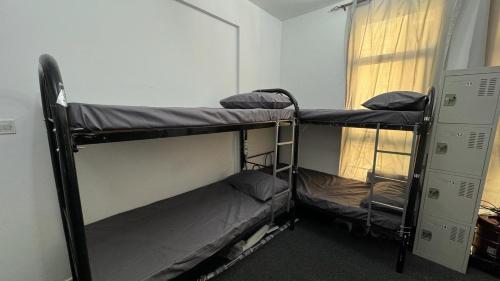 two bunk beds in a room with a window at Golden Horse Hostel in Dubai