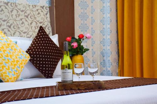 馬拉里的住宿－Hotel Hadimba Manali By YB Hotels，一张桌子,上面放有两瓶葡萄酒和两杯酒