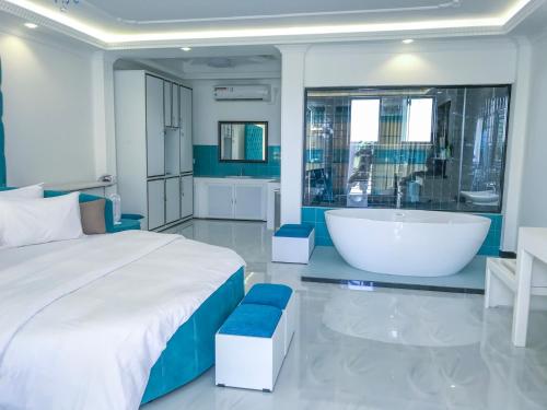 a bedroom with a large bed and a bath tub at The Lion Kingdom Sigiriya in Sigiriya