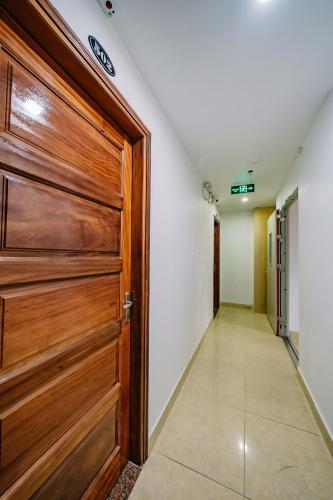 a hallway with a wooden door and a corridor at Phuong Dong Hotel in Cat Ba