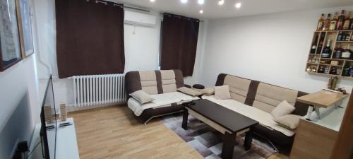 a living room with a couch and a table at Mokusnice in Zenica