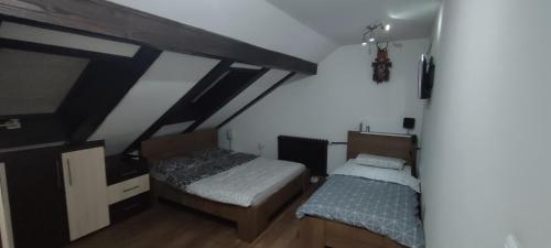 a bedroom with two beds in a attic at Mokusnice in Zenica