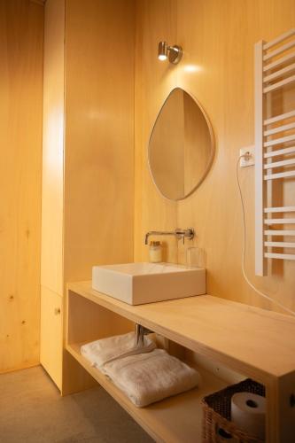 a bathroom with a sink and a mirror at Casa Raposa Lodges - Terrace Mountain View in Manteigas