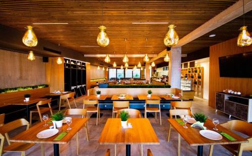 a restaurant with wooden tables and chairs and a bar at Residence Trafick in Prague