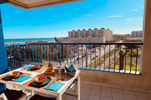a balcony with a table and a view of a city at Apto. luminoso con vistas en playa de La Patacona in Valencia