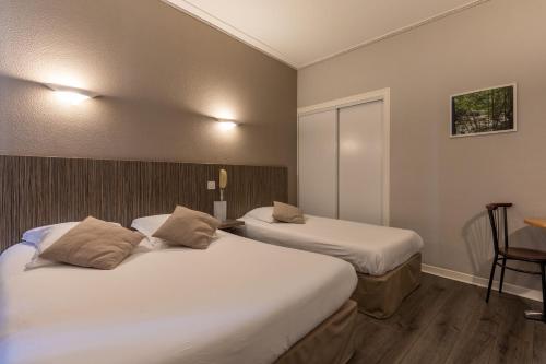 Una cama o camas en una habitación de Hôtel Café les Fleurs