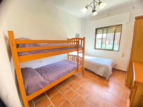 a bedroom with two bunk beds in a room at VILLA LÚA in Cartaya
