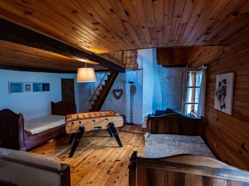 a room with a bed and a table in it at Bergerie Ariégeoise in Ustou