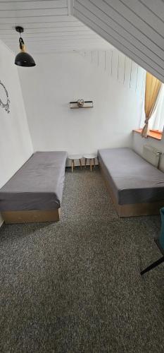 a room with two beds in a room at Ubytovanie u Vlka in Ľubotice