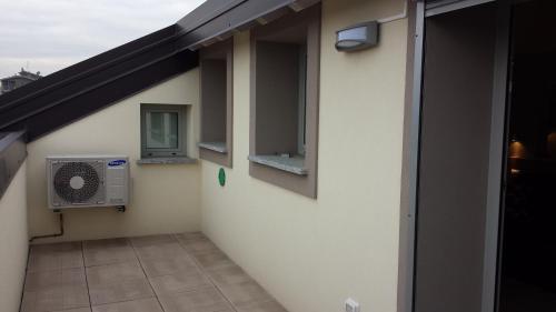 a balcony with a air conditioner on the side of a building at Residence Luna di Monza in Monza