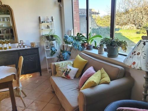 a living room with a couch with pillows on it at Les Tilleuls d'Elisée in Vaison-la-Romaine