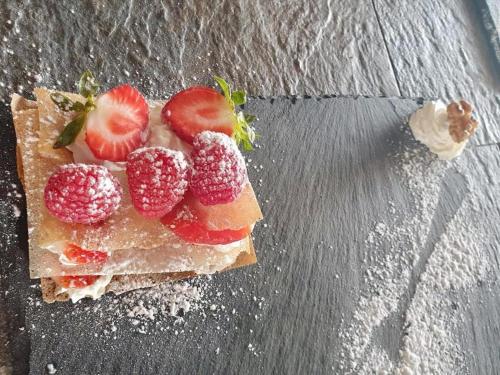a piece of bread with strawberries on top of it at Atlas surf in Tamraght Ouzdar
