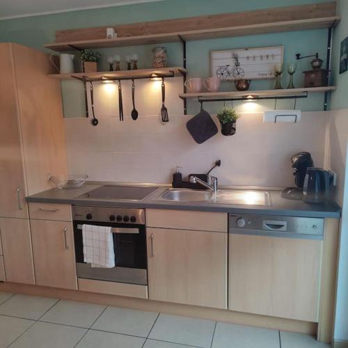 a kitchen with a sink and a stove at FeWo Hope in Lindwedel
