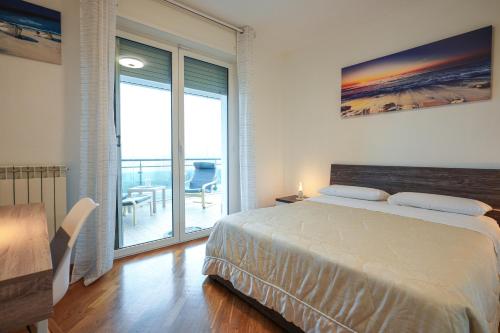 a bedroom with a bed and a balcony at Nuvola Apartment Fiumicino Easy Self check-in in Fiumicino