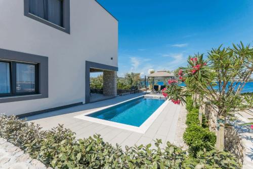 a swimming pool in the backyard of a house at Royal House 1 in Pašman