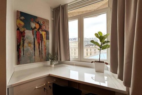 a room with a window with a potted plant on a counter at Main Square Heaven in Skopje