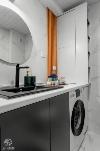 a kitchen with a washing machine and a sink at Four Seasons Luxury Apartment in Bitola