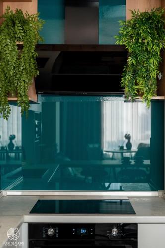 a kitchen counter with a window and some plants at Four Seasons Luxury Apartment in Bitola