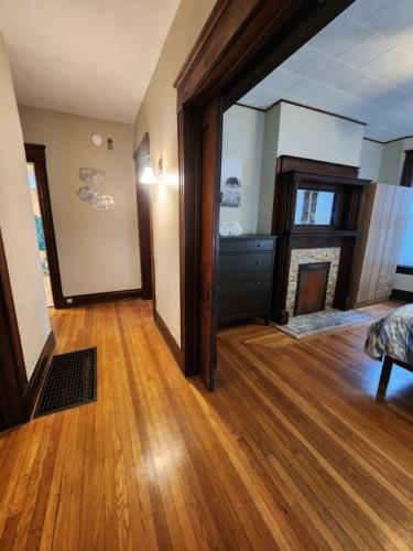 an empty living room with a fireplace in a house at Cleneay #1 Private 3 Bed near Xavier & Downton in Cincinnati