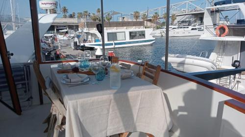 a table on a boat in the water with boats at Yacht y fiestas in Barcelona