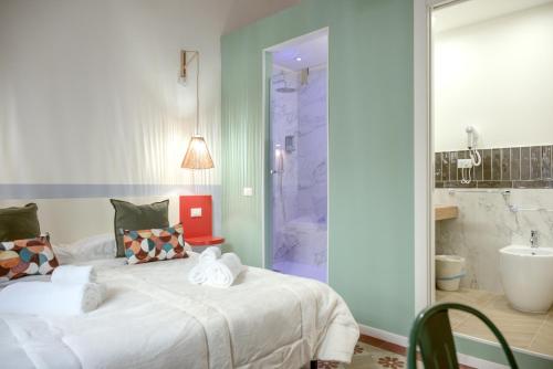 a bedroom with a bed and a tub and a sink at Le Dame di Sicilia Sicilian Vintage Rooms in Palermo