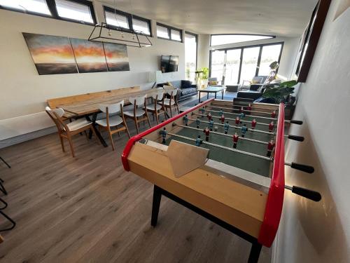a room with a pool table and ping pong ball at Houseboat Islay in Bembridge