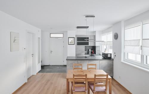 a kitchen and dining room with a wooden table and chairs at Wohnen in Wattens Top 3 in Wattens