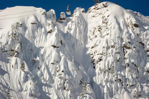a mountain covered in snow with a ski lift at Palisades Tahoe Lodge Rentals Studio #234 in Olympic Valley