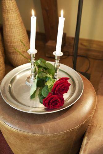 a plate with two candles on top of a table at Ulfsunda Slott in Stockholm
