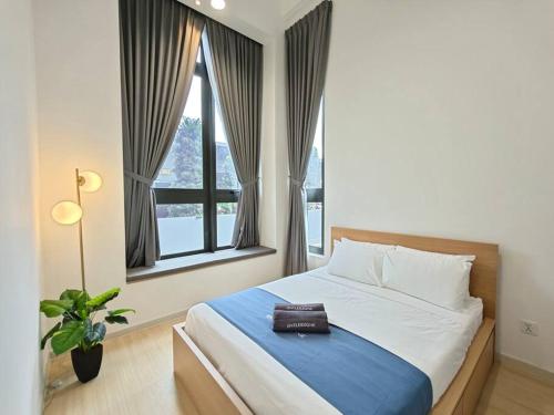 a bedroom with a bed with a purse on it at Sunway Grid by Antlerzone in Kangkar Pendas