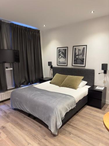 a bedroom with a large bed and a large window at Studio Wijkhuizen in Zandvoort
