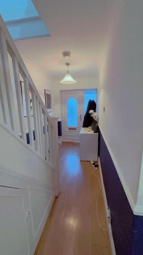 a hallway of a home with a staircase and a window at Small room with double bed in Plumstead