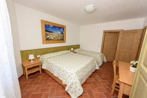 a bedroom with two beds and two cabinets at Agritur La Pieve in Taio